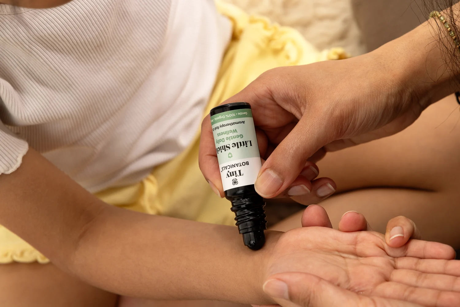 Little Shield Daily Wellness Roll-On applied to a child’s wrist