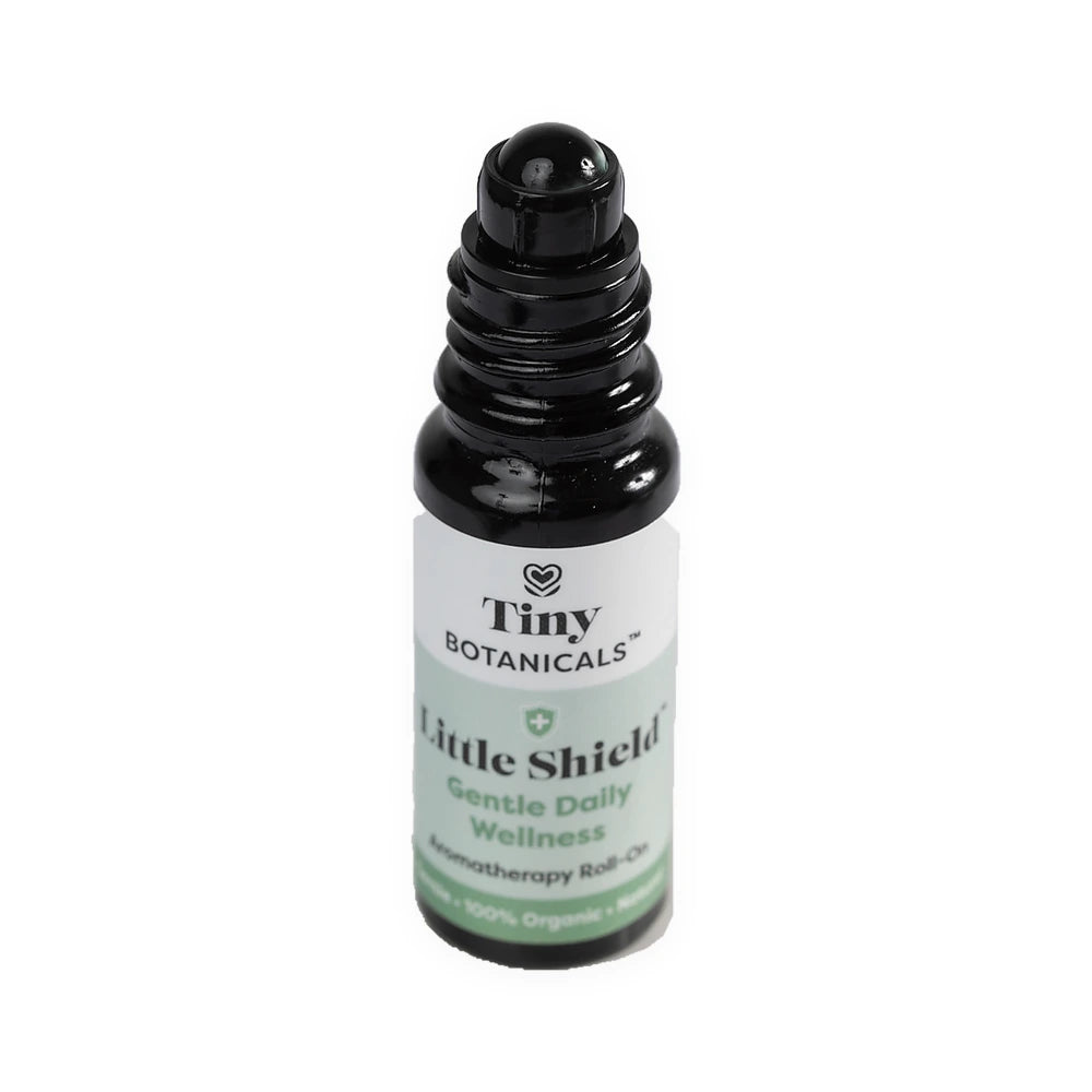 Little Shield bottle with its cap removed, showing the built-in rollerball